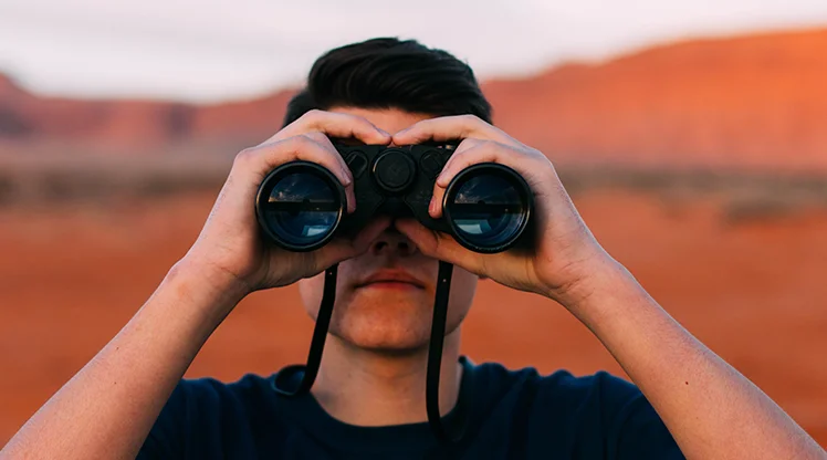 Man looking in binoculars