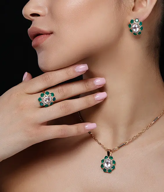 Flower-shaped jewelry set with green gemstones, including earrings, ring, and pendant
